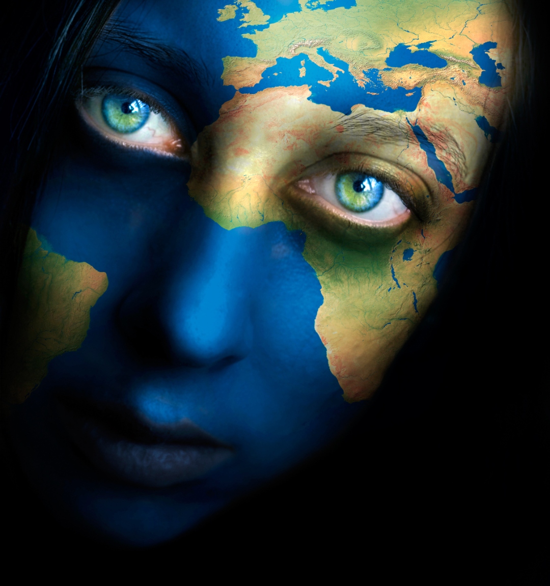 Camelian — earth map painted across a woman's face, blue eyes
